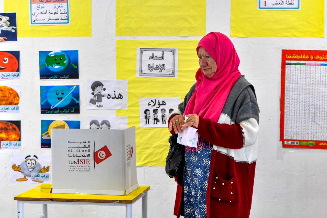 Tunisia's President Kais Saied, accompanied by his wife first lady Ichraf Saied, speaks to reporters after voting in the 2023 local elections in the locality of Mnihla in Ariana province on the outskirts of Tunis on December 24, 2023. (AFP)