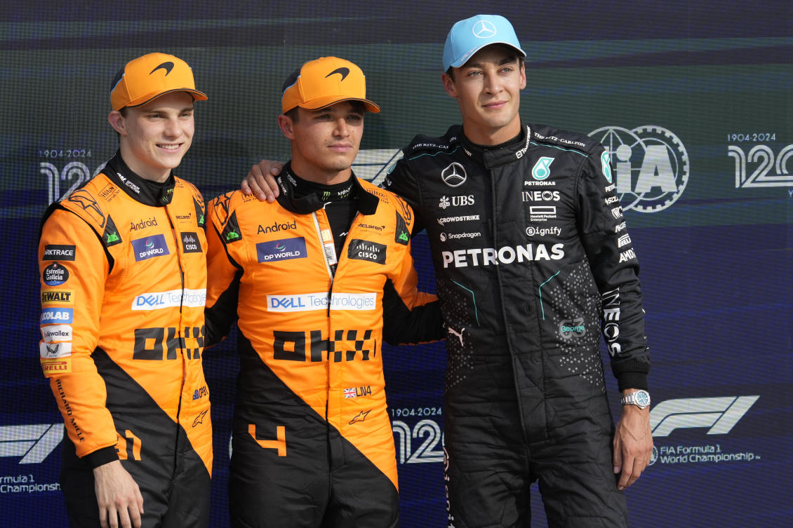 McLaren driver Lando Norris of Britain, center, celebrates his pole position with second placed McLaren driver Oscar Piastri of Australia, left, and third Mercedes driver George Russell of Britain after qualifying session ahead of the Formula One Italian Grand Prix race at the Monza racetrack, in Monza, Italy, Saturday, Aug. 31, 2024. (AP)