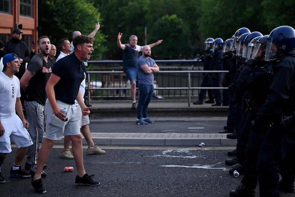 Police officers face off with protesters during demonstration called by far-right activists in Bristol on Aug. 3, 2024. (AFP)