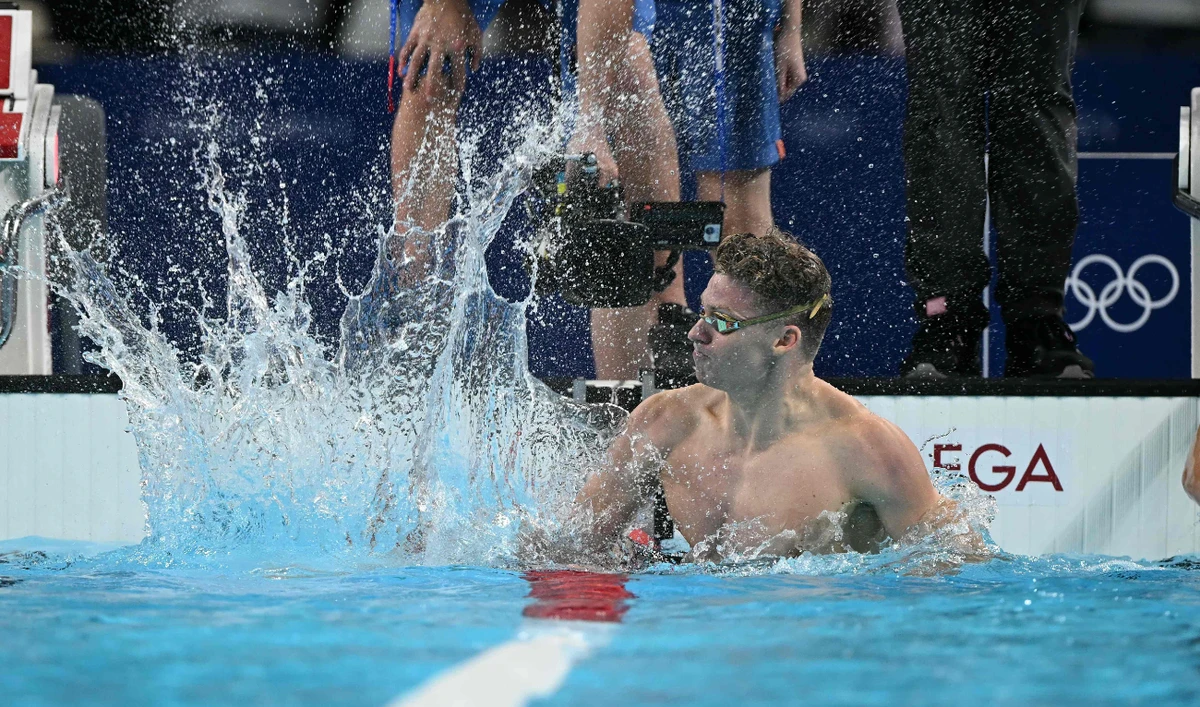 France's Leon Marchand celebrates after winning gold in an Olympic record in the final of the men's 200m breaststroke swimming event during the Paris 2024 Olympic Games at the Paris La Defense Arena in Nanterre, west of Paris, on July 31, 2024. (AFP)