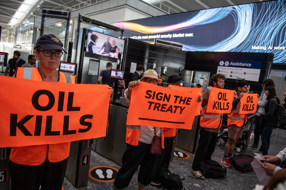 Above, climate activists block entry gates inside Heathrow Airport’s departure area. (X:@JustStop_Oil/Guy Smallman)