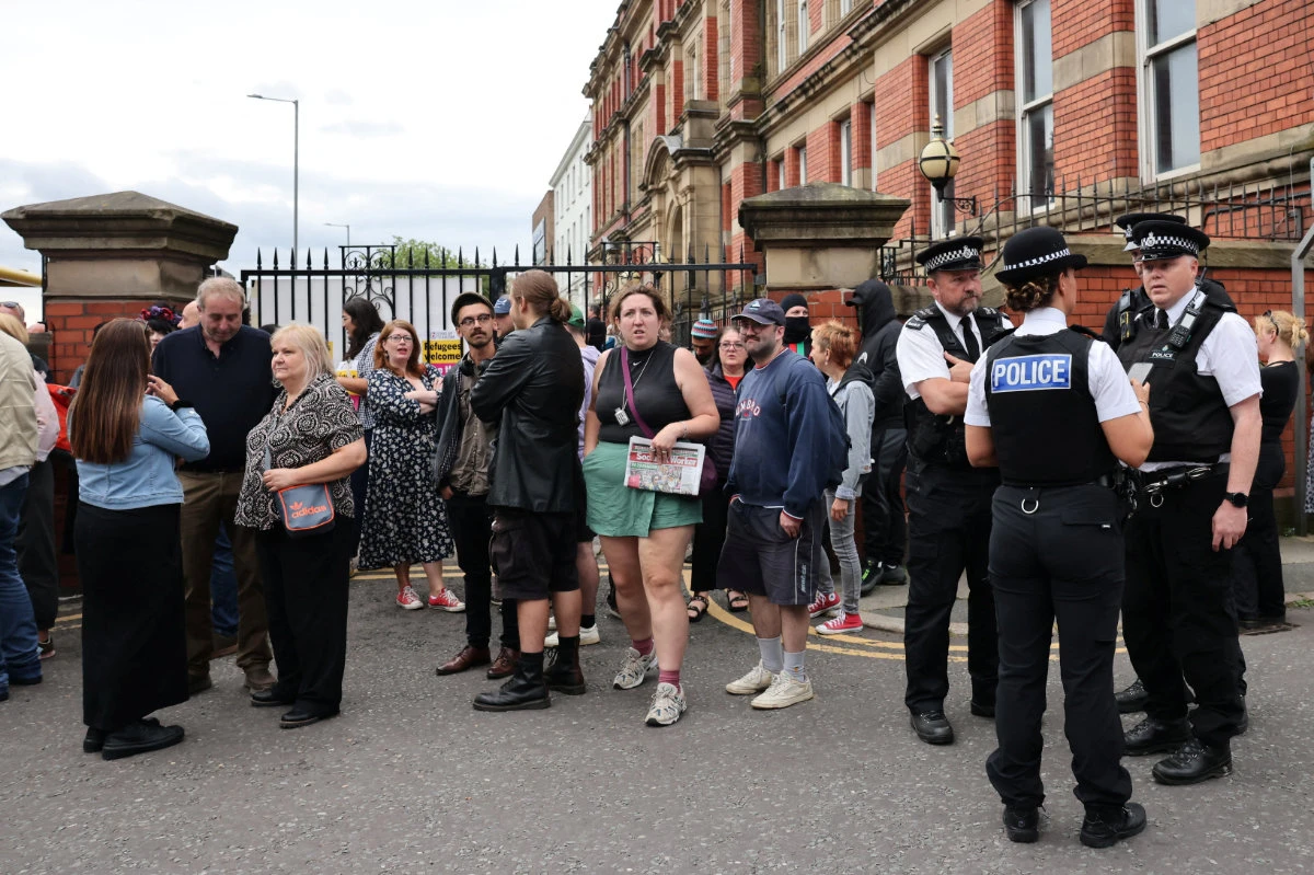 People take part in a protest outside a mosque in Liverpool, UK, on August 2, 2024. (REUTERS)