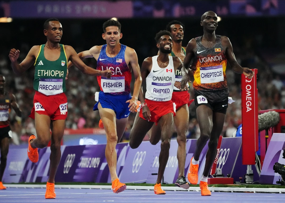 Joshua Cheptegei of Uganda crosses the finish line to win the men’s 10,000m final in an Olympic record at the Paris 2024 Olympics athletics competition Friday. (Reuters)