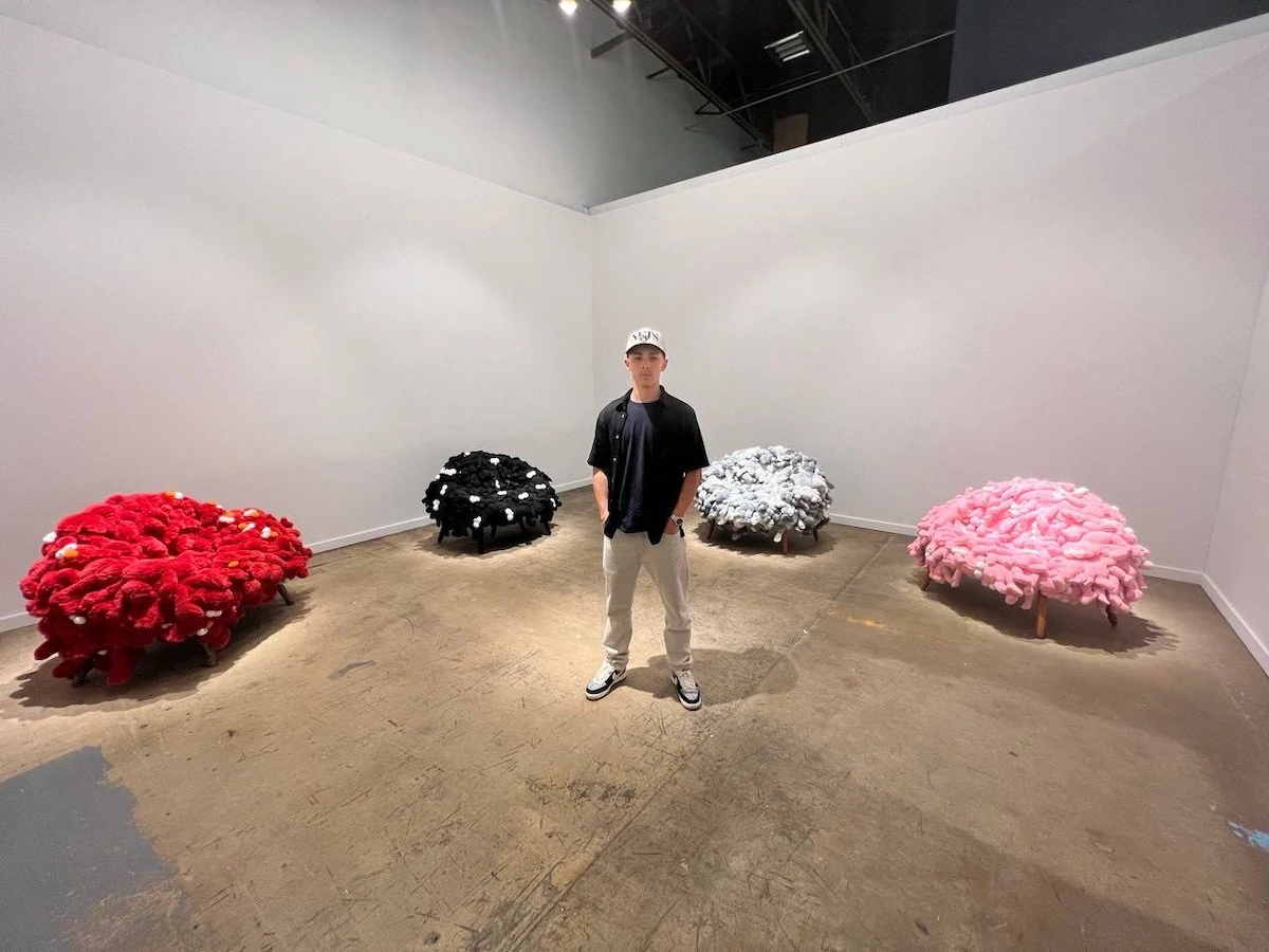 Levi Pastor with luxury furniture KAWS x Campana Companion Plush Chairs fetching over $300,000 each. (Supplied)