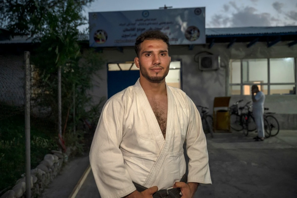 Afghan judo fighter Mohammad Samim Faizad poses for photos after a training session at the Afghanistan Judo Federation in Kabul, ahead of his participation in the Paris 2024 Olympic Games. (AFP)
