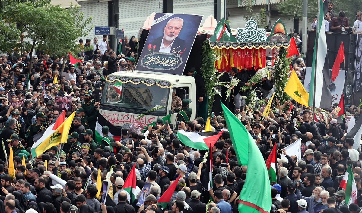 Iranians take part in a funeral procession for late Hamas leader Ismail Haniyeh, in Tehran, on August 1, 2024, ahead of his burial in Qatar. (AFP)