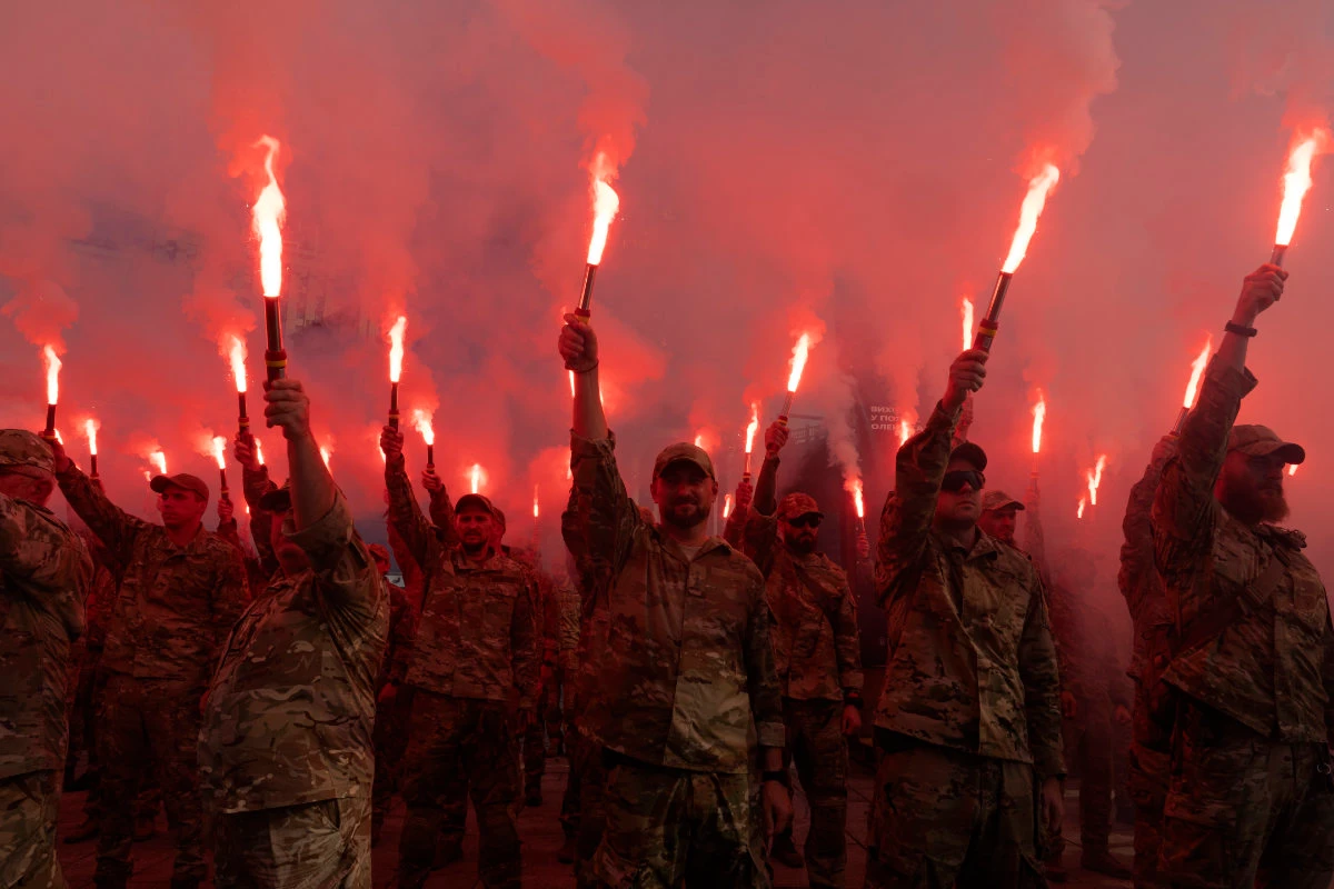 Soldiers of Ukraine's Azov battalion light flares at a rally on July 28, 2024 at the Independence Square in Kyiv, demanding the release of Ukrainian prisoners of war who are held in captivity in Russia. (AP)