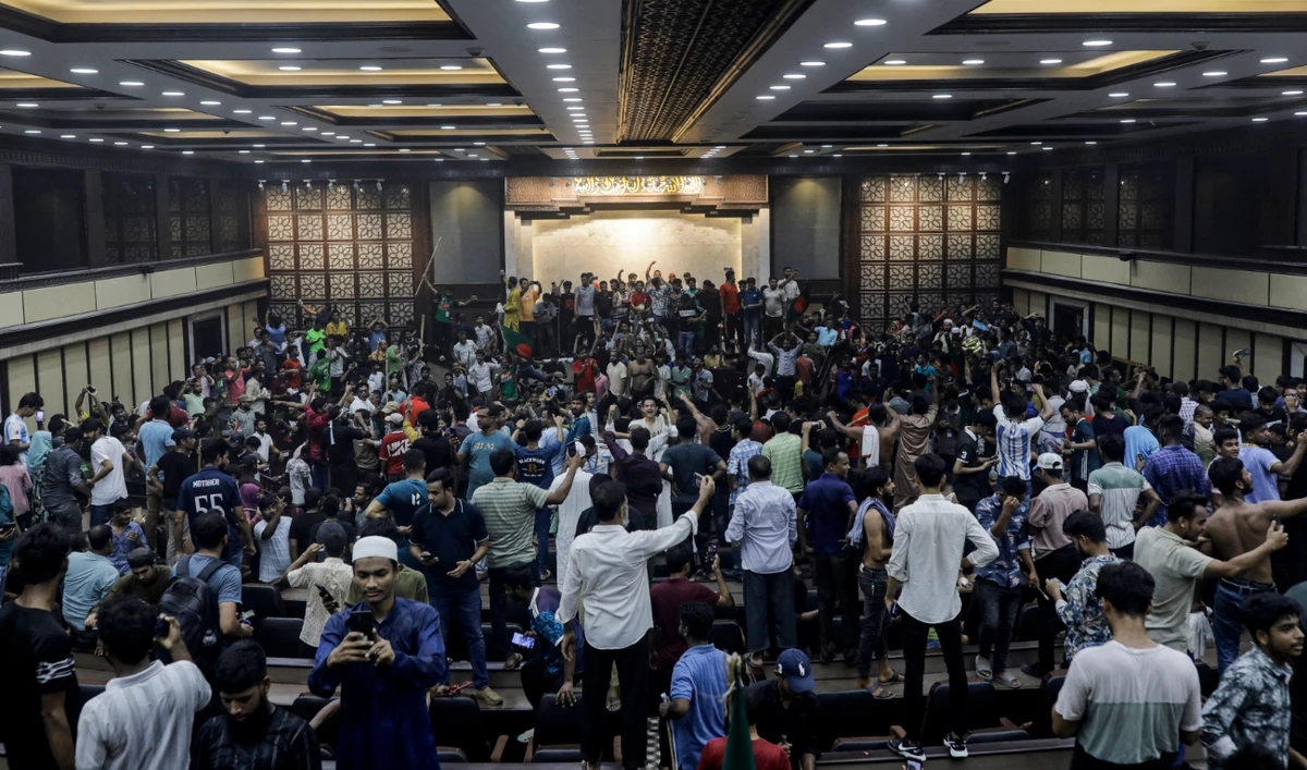 Anti-government protestors gather to vandalise Prime Minister Sheikh Hasina's palace in Dhaka on August 5, 2024. (AFP)