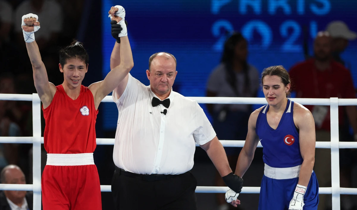 Yu Ting Lin of Taiwan has her hand raised after winning her fight against Esra Yildiz Kahraman of Turkey in the women's 57kg semifinal at the Paris 2024 Olympics at Roland Garros Stadium, Paris, on Wednesday. (Reuters)