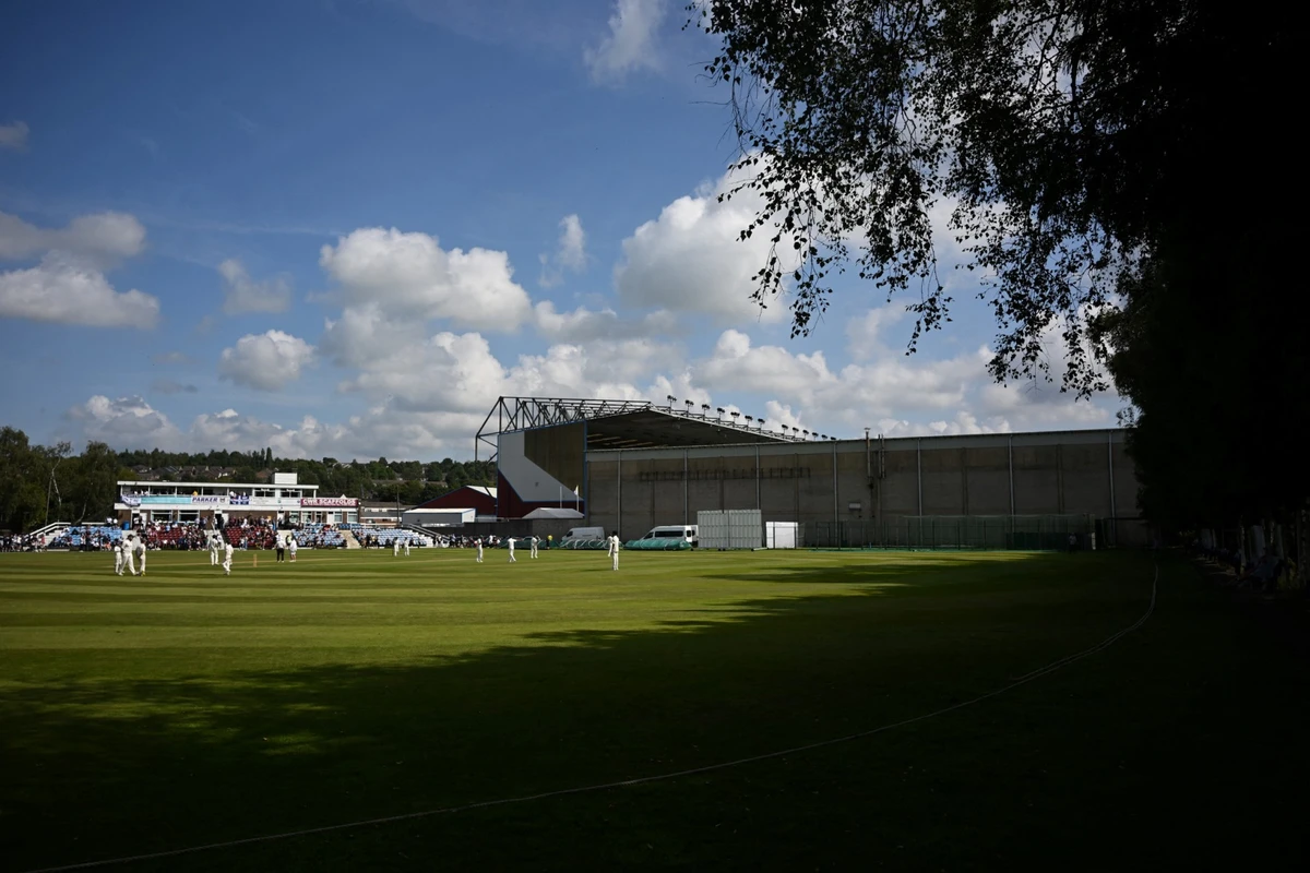 File photo of People play cricket outside Turf Moor in Burnley, north-west England (AFP)