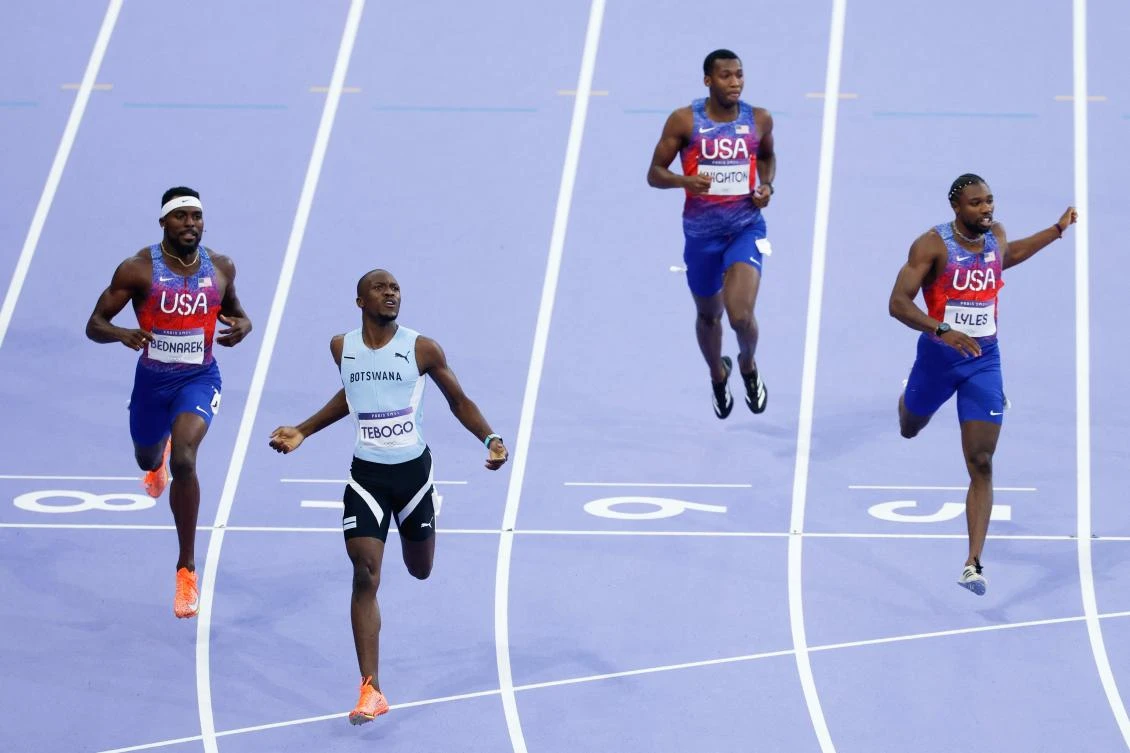 Botswana’s Letsile Tebogo, US’ Kenneth Bednarek and US’ Noah Lyles cross the finish line to finish first, second and third respectively in the men’s 200m final of the athletics event at the Paris 2024 Olympic Games at Stade de France in Saint-Denis, on Aug. 8, 2024. (AFP)