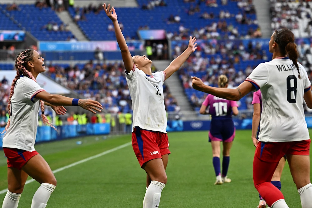 Members of the US women’s football celebrate their semifinal match against Germany at the Paris 2024 Olympics. (AFP)