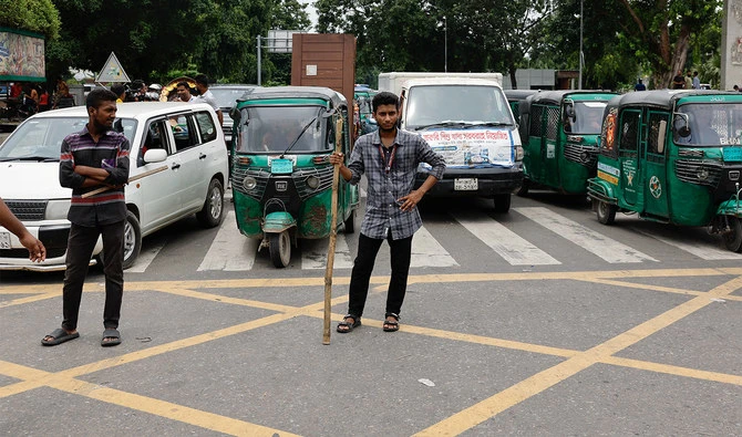Civilians stand on the road to control traffic at the Bijoy Sarani intersection, a day after the resignation of Bangladeshi Prime Minister Sheikh Hasina, in Dhaka, Bangladesh, on August 6, 2024. (REUTERS)