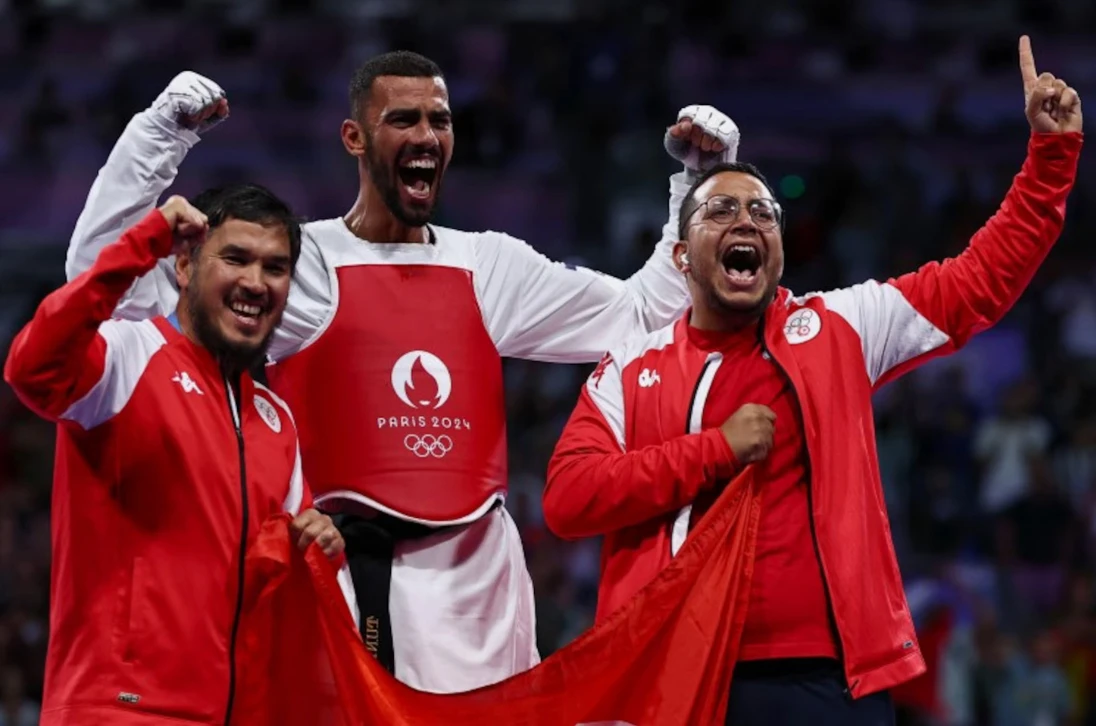 Firas Katoussi of Tunisia celebrates winning his bout against Mehran Barkhordari of Iran. (Reuters)