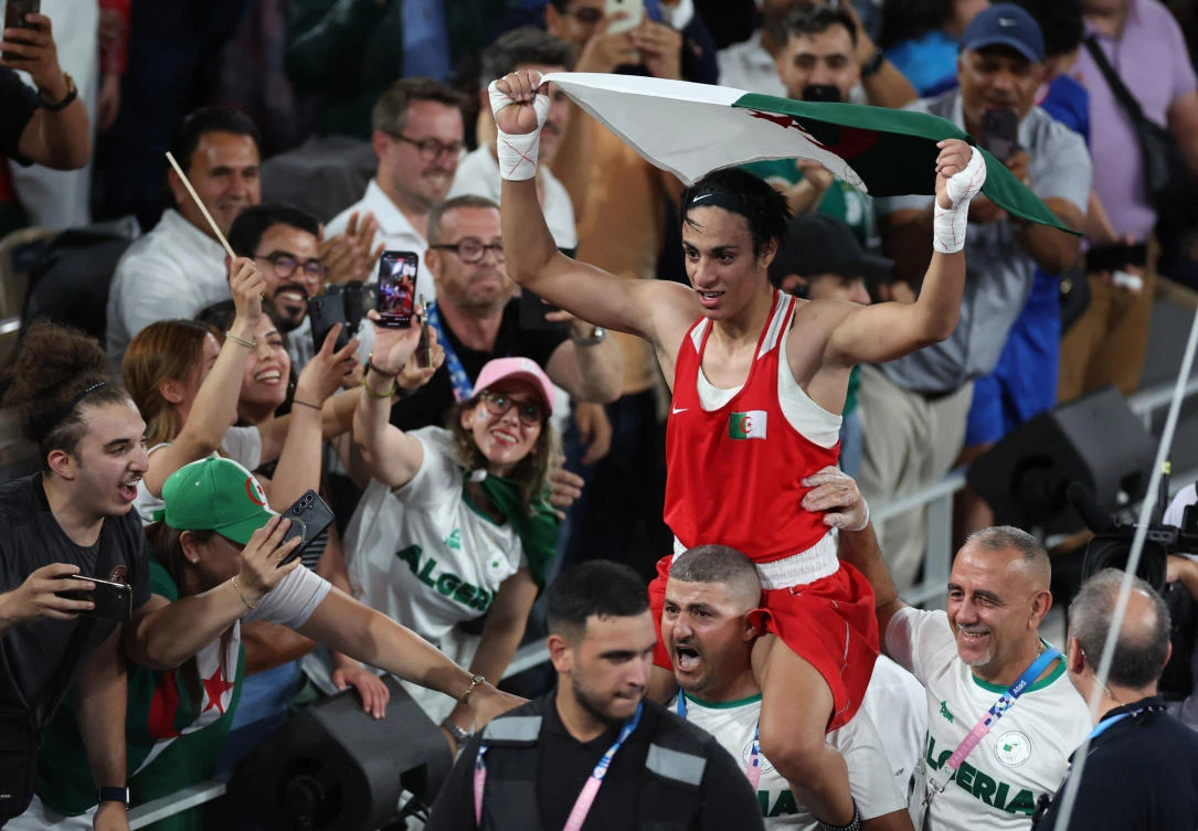 Imane Khelif of Algeria holds an Algerian flag as she celebrates winning against Liu Yang of China at the Paris 2024 Olympics — Boxing — Women’s 66kg — Final — at Roland-Garros Stadium, on Aug. 9, 2024. (Reuters)