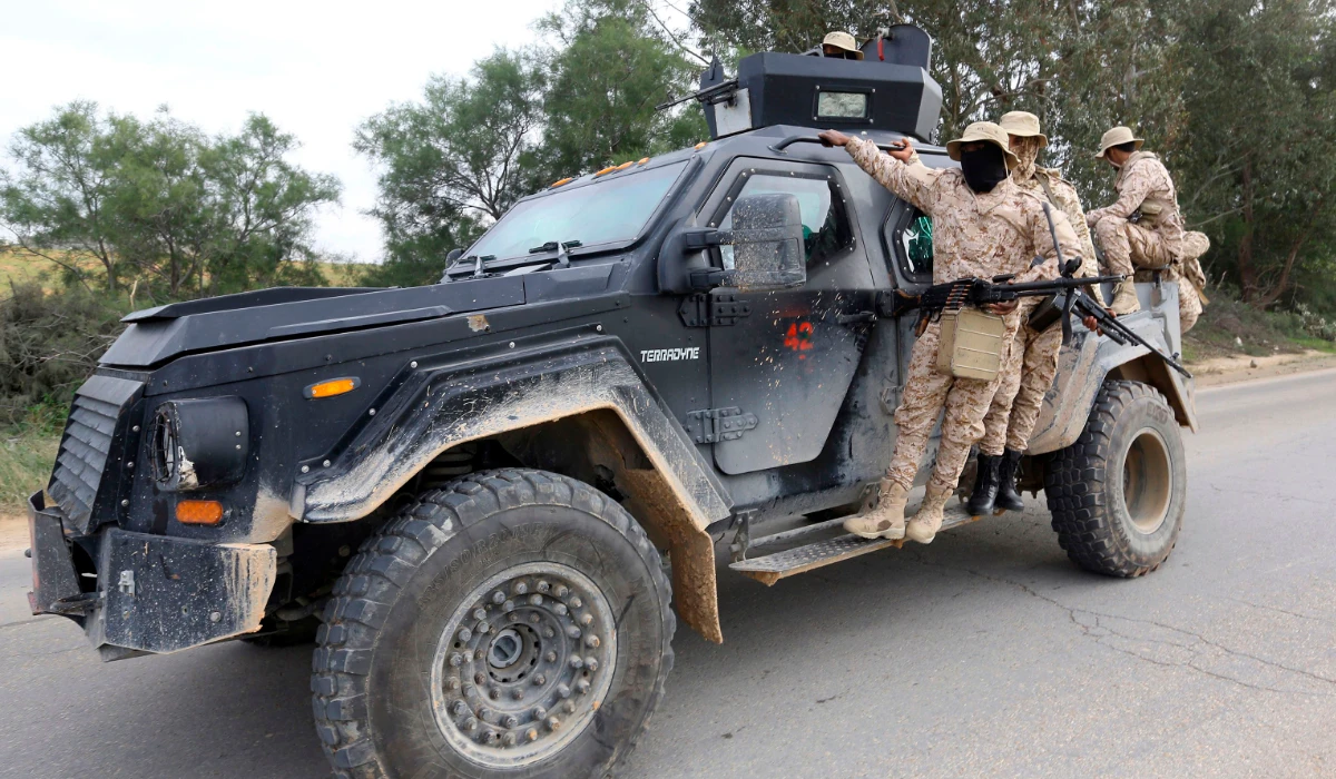 Members of the Tripoli Protection Force, an alliance of militias from the capital city, patrol an area south of the Libyan capital on January 18, 2019, during clashes with the Seventh Brigade group from the town of Tarhuna. (AFP)