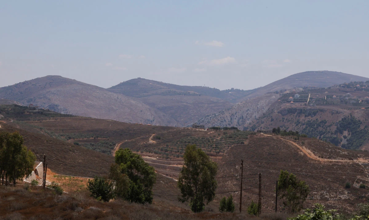 A general view shows villages near the Lebanese-Israeli border, as pictured through a balcony in Kamel Mroue's house, in Yohmor, Nabatieh governorate, Lebanon, August 11, 2024. (Reuters)