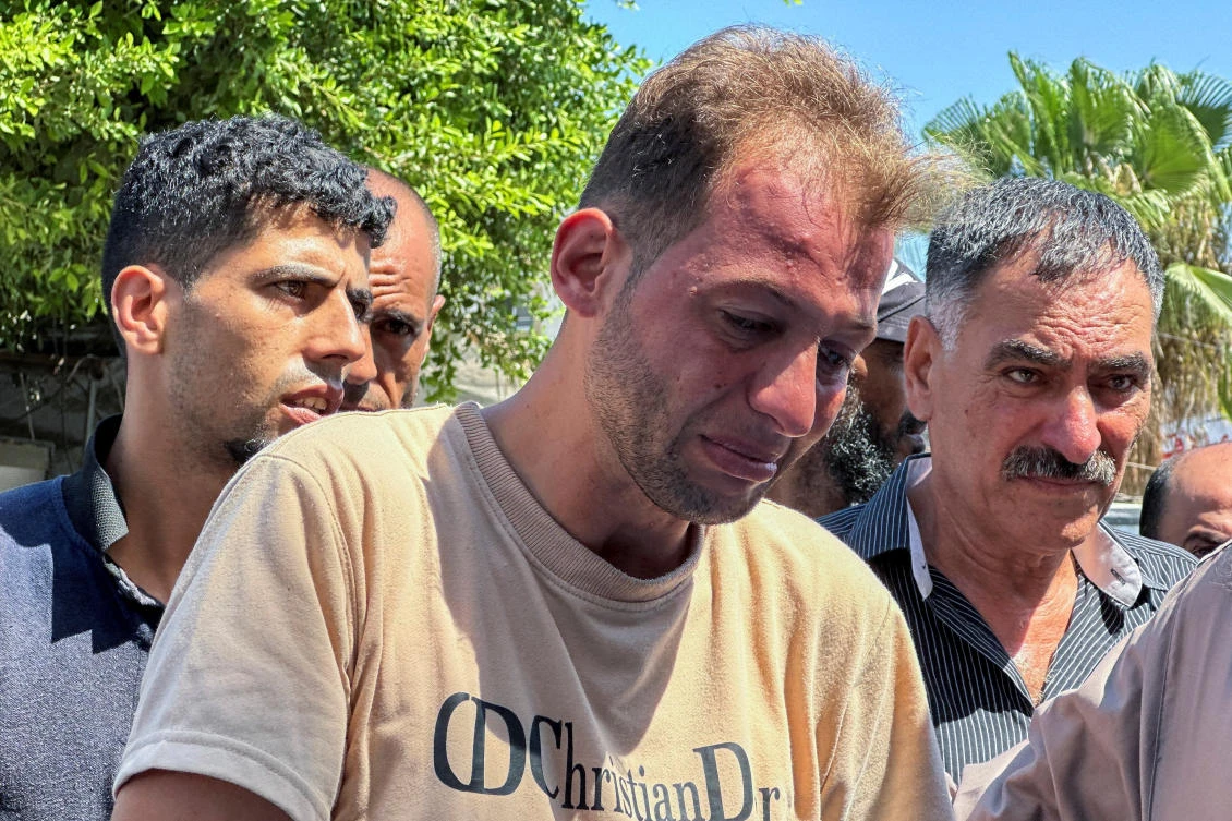 Mohammed Abu Al-Qumsan, whose wife Jumann and newborn twins Asser and Ayssel were killed in an Israeli strike while he was brining the twins’ birth of certificates, according to medics, reacts at a hospital, in Deir Al-Balah in the central Gaza Strip, Aug. 13, 2024. (Reuters)