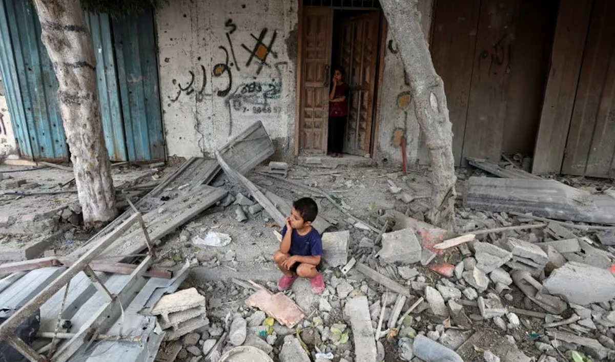 A Palestinian boy sits at the site of an Israeli strike on a house, amid the Israel-Hamas conflict, in Maghazi refugee camp in the central Gaza Strip, August 14, 2024. (REUTERS)