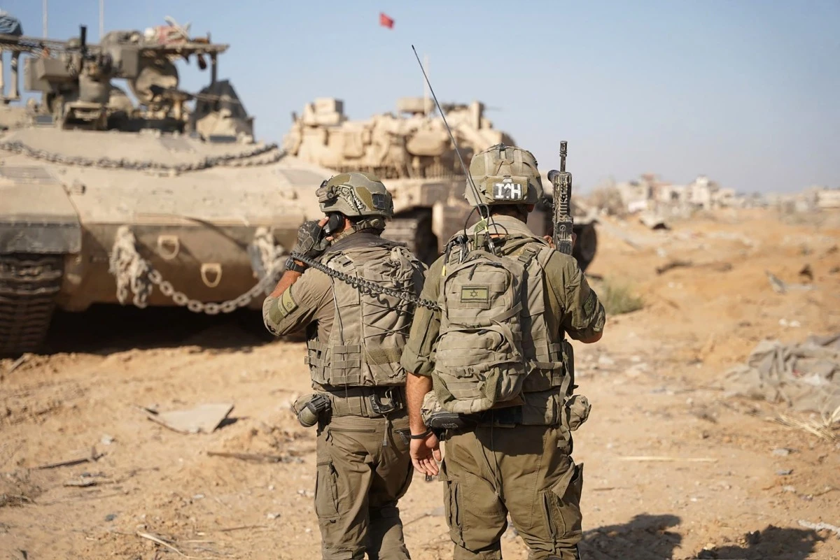 Israeli troops and armoured vehicles operating on the ground in the Gaza Strip amid the continuing conflict between Israel and Hamas (AFP)
