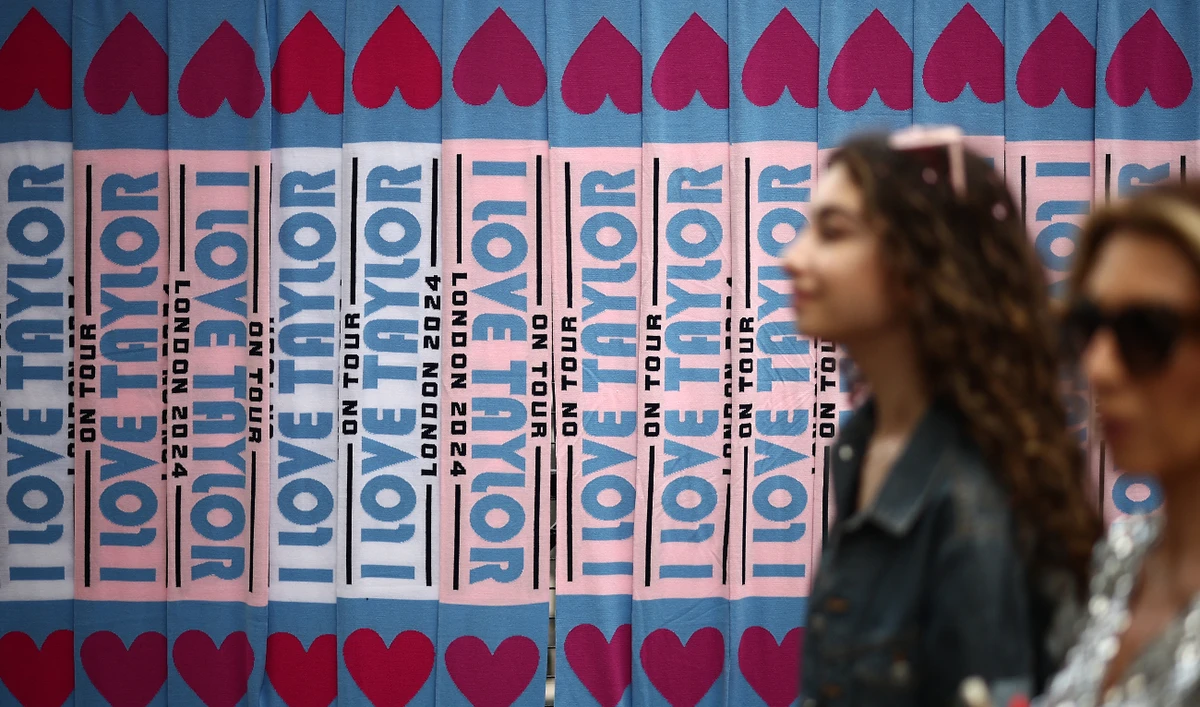 Fans of US mega-star Taylor Swift, so-called "Swifties", pass merchandise stalls outside Wembley Stadium in London on August 15, 2024, ahead of the first of five concerts she is playing at the stadium. (AFP)