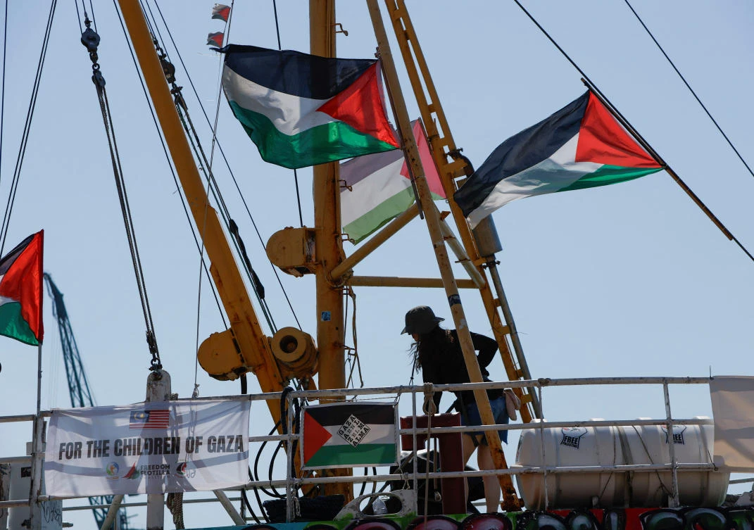 An activist washes the deck of the Freedom Flotilla Coalition ship ‘Handala’ as they prepare to sail for Gaza in an attempt to break a long-standing Israeli blockade and deliver humanitarian aid in Marsa, Malta on Aug. 16, 2024. (Reuters)