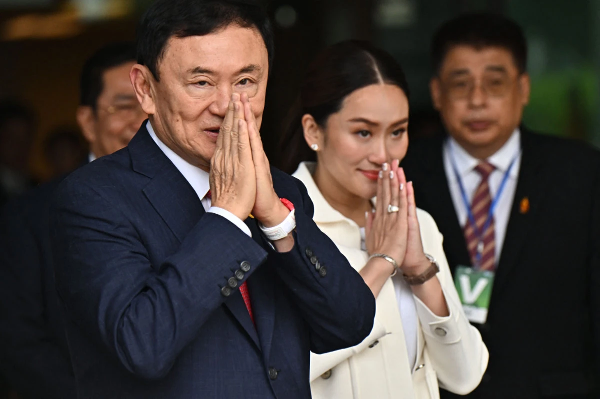 Former Thai Prime Minister Thaksin Shinawatra greets his supporters after landing at Bangkok's Don Mueang airport on August 22, 2023. (AFP)