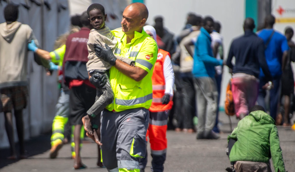 An emergency team member carries a child rescued from a boat in the port of La Restinga on the Canary Island of El Hierro, Spain. (AP)