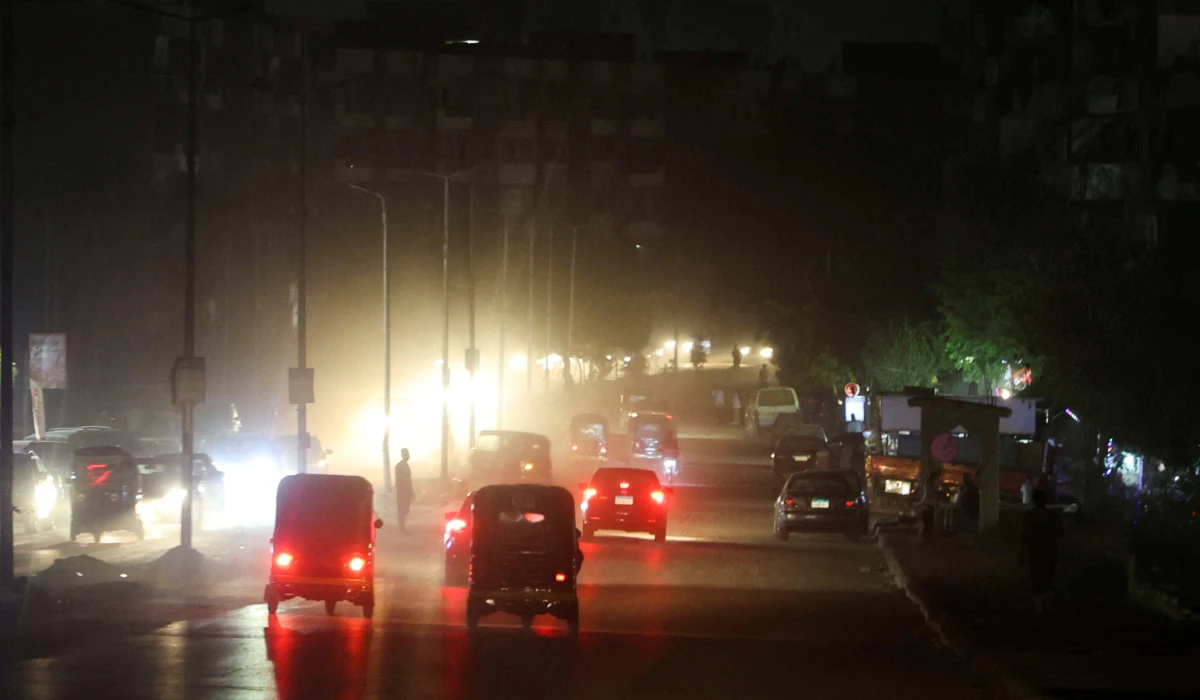A general view shows vehicles and people walking through dark roads as power cuts to reduce energy consumption are executed by the Egyptian government during the current brutal heat wave, in Cairo, Egypt August 3, 2023. (REUTERS)