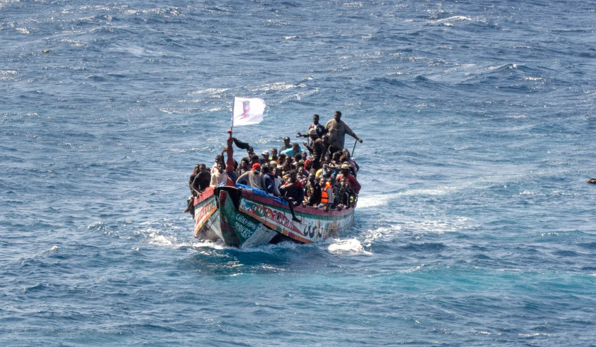 Migrants crowd a wooden boat as they sail to the port in La Restinga on the Canary island of El Hierro, Spain, Sunday, Aug. 18, 2024. (AP)