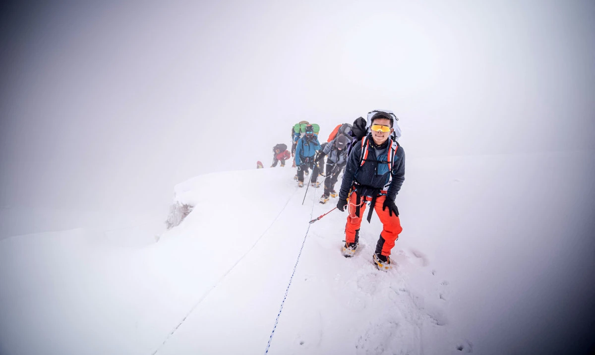 In this handout photograph taken on May 23 and released by 14 Peaks Expedition, Nepali mountaineer Nima Rinji Sherpa ascends the summit of Mount Everest. (AFP)
