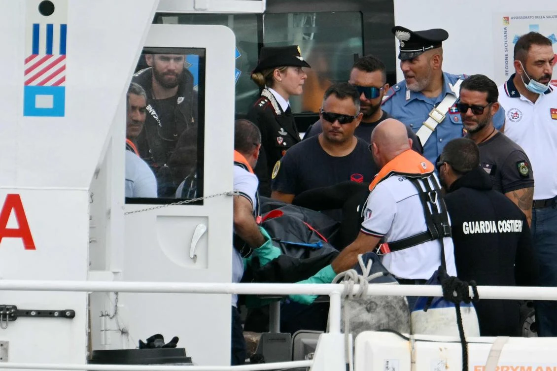 Italian Coast Guards (Guardia Costiera) carry a body in Porticello near Palermo, on August 21, 2024 two days after the British-flagged luxury yacht Bayesian sank. The Bayesian, which had 22 people aboard including 10 crew, was anchored some 700 meters from port (AFP)