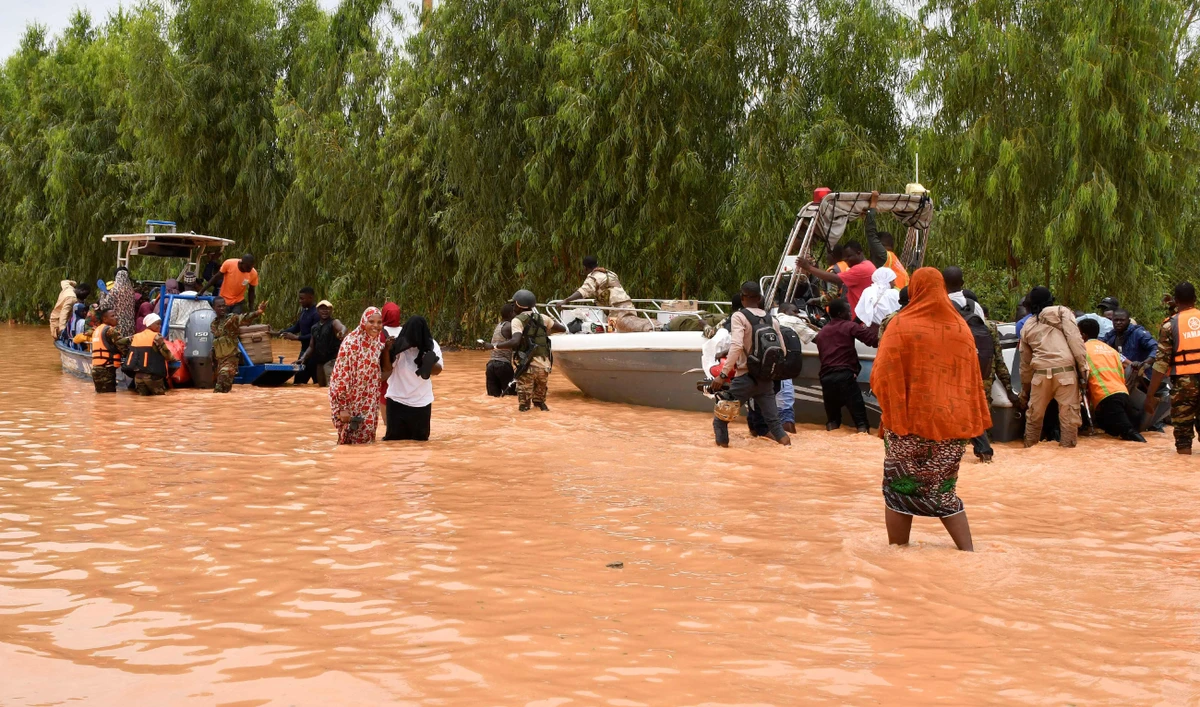 This photograph taken on August 20, 2024 shows police boats being used to carry people following heavy rains that damaged National Road 25 from the Nigerien capital Niamey to the provinces of Tillabéri and Tahoua in western Niger. (AFP)