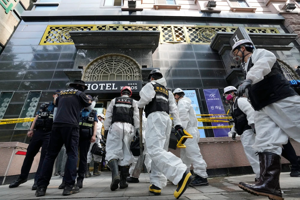 A joint investigation team arrives to examine the site of a hotel burnt in a fire in Bucheon, South Korea on Aug. 23, 2024. (AP)