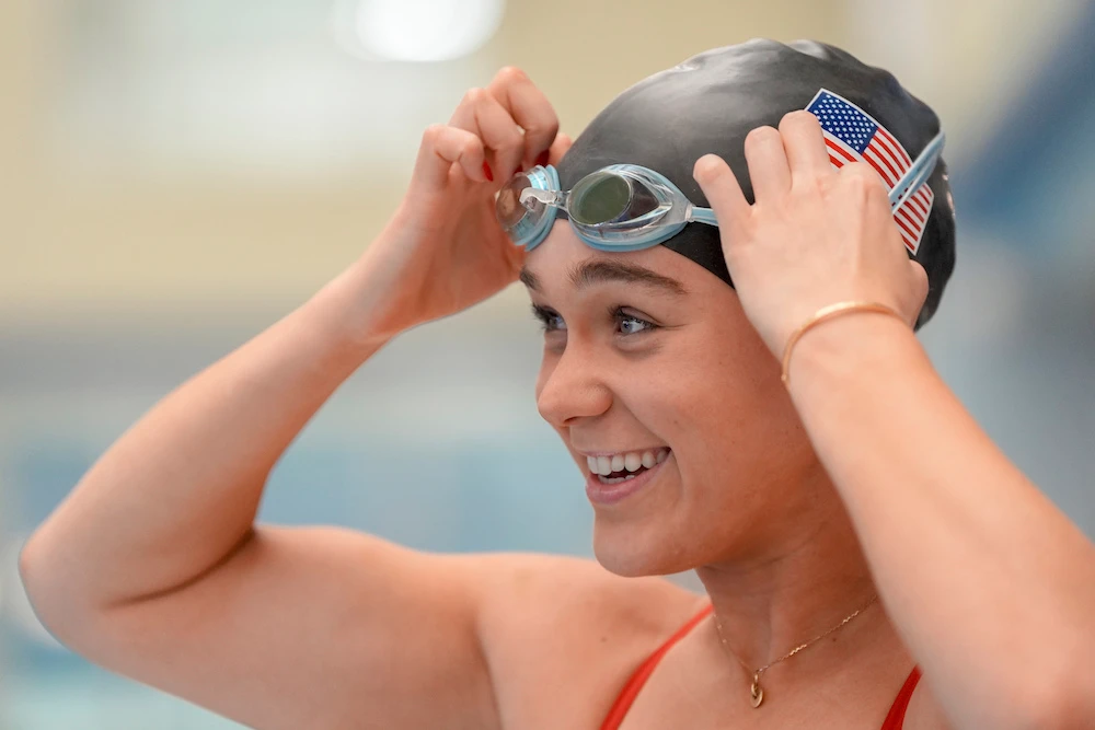 Paralympic swimmer Ali Truwit puts on goggles before practice at Chelsea Piers Athletic Club on Aug. 2, 2024 in Stamford, Conn. (AP)