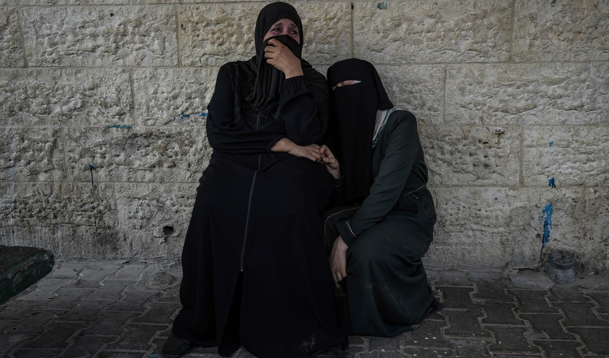 Palestinian women mourn their relatives killed in the Israeli bombardment of the Gaza Strip, at a hospital in Deir al-Balah, on August 27, 2024. (AP)