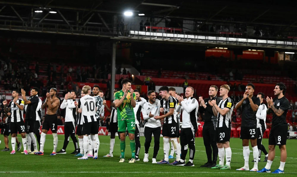 Newcastle United players celebrate at the end of the English League Cup second round football match between Nottingham Forest and Newcastle United at The City Ground in Nottingham, central England, on Aug. 28, 2024. (AFP)