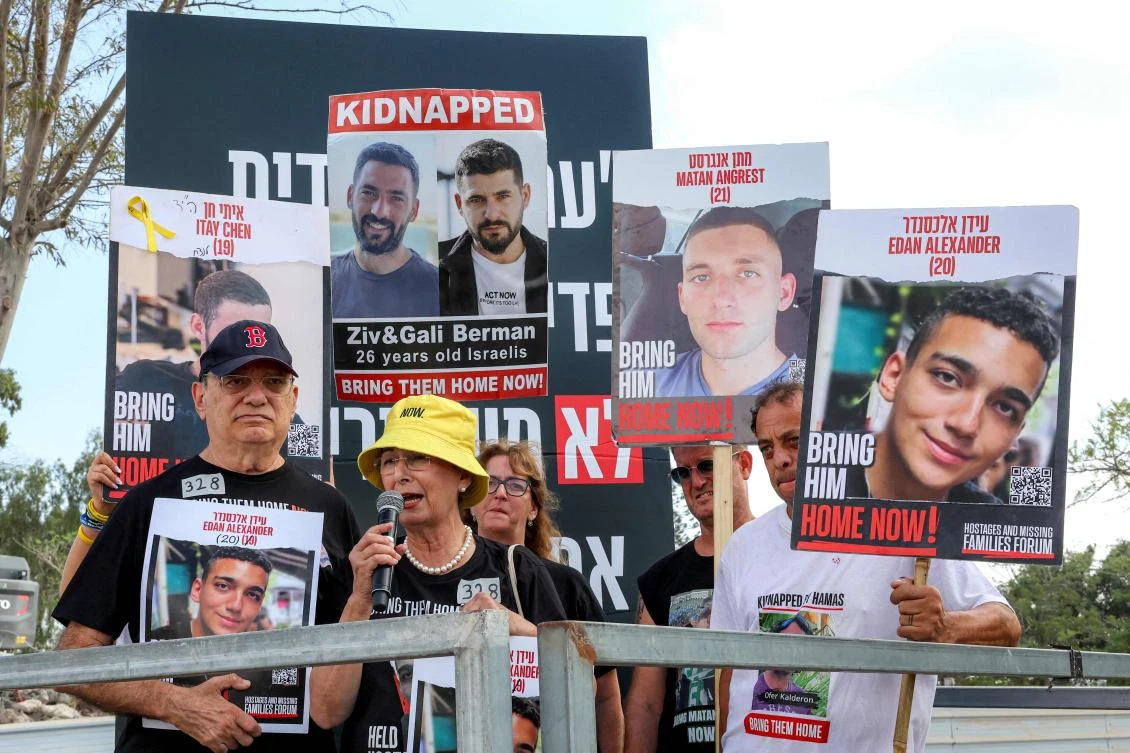 Relatives of Israeli hostage Edan Alexander speak during a demonstration near Kibbutz Nirim in southern Israel by the border with Gaza on August 29, 2024. (AFP)