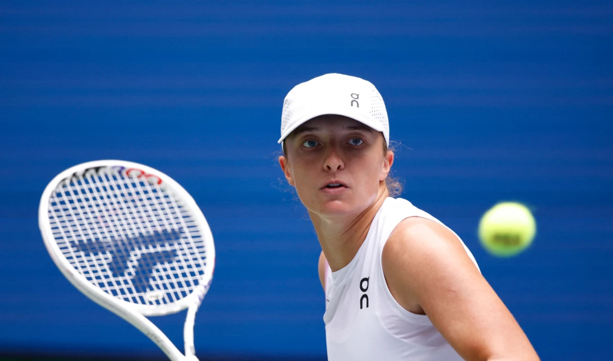 Poland's Iga Swiatek hits a return to Ena Shibahara of Japan during their women's singles second round tennis match on day four of the US Open tennis tournament at the USTA Billie Jean King National Tennis Center in New York City, on August 29, 2024. (AFP)