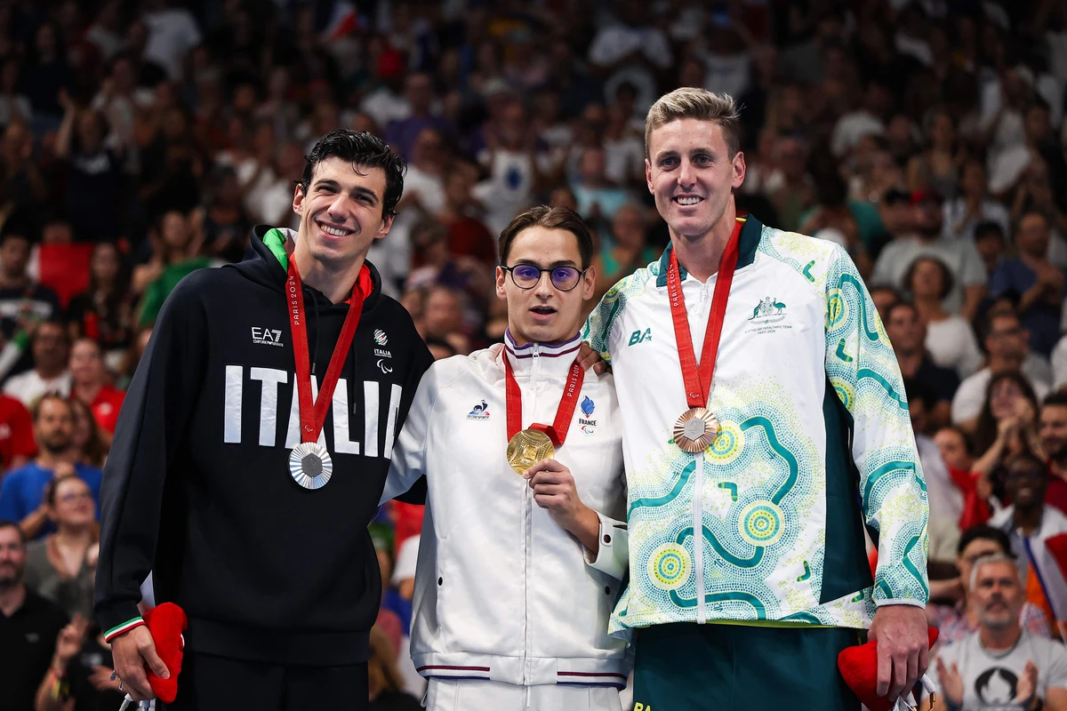 (L/R) Silver medalist Italy's Simone Barlaam, gold medalist France's Ugo Didier and bronze medalist Australian Brenden Hall celebrate on the podium of the men's S9 400m freestyle swimming event during the Paris 2024 Paralympic Games at The Paris La Defense Arena in Nanterre, west of Paris on Aug. 29, 2024. (AFP)