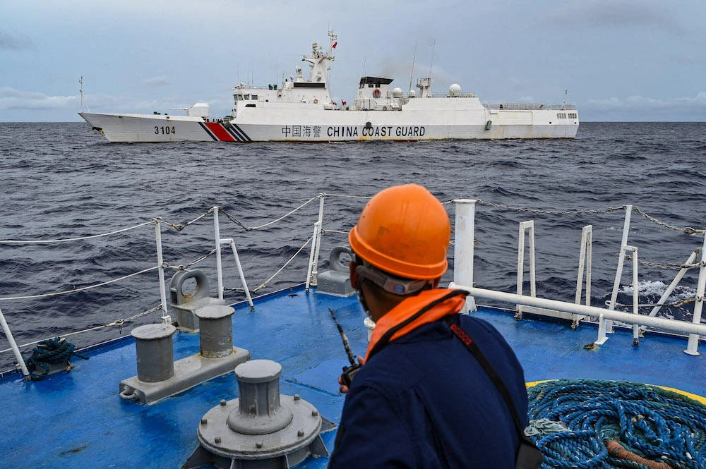 The Philippine coast guard has accused China of building an artificial island at Sabina Shoal, while China has said ‘illegal’ beaching by Philippine warships at the Spratly Islands. Above, a China coast guard ship as seen from a Philippine coast guard vessel in disputed waters of the South China Sea on Aug. 26, 2024. (AFP)