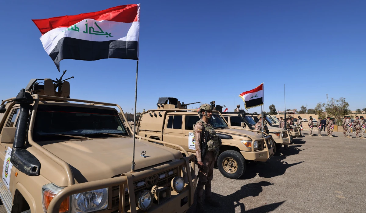 Iraqi soldiers from the new 'desert battalion' special forces stand next to military vehicles as the take part in a graduation ceremony in Anbar west of Baghdad on February 29, 2024. (AFP)