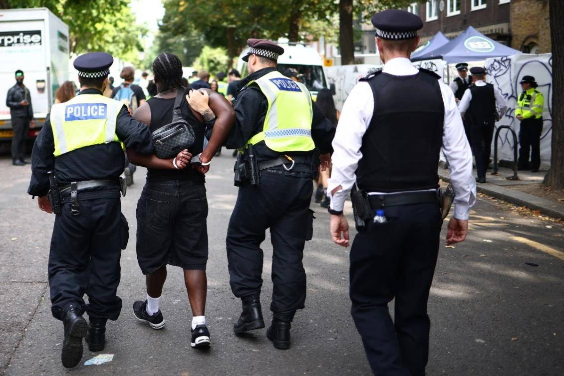 Police officers make an arrest at the Notting Hill Carnival in west London on August 26, 2024. (AFP)