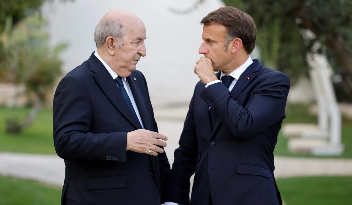 France's President Emmanuel Macron (R) talks with Algeria's President Abdelmadjid Tebboune (L) as they attend the G7 Summit hosted by Italy at the Borgo Egnazia resort in Savelletri on June 13, 2024. (AFP)