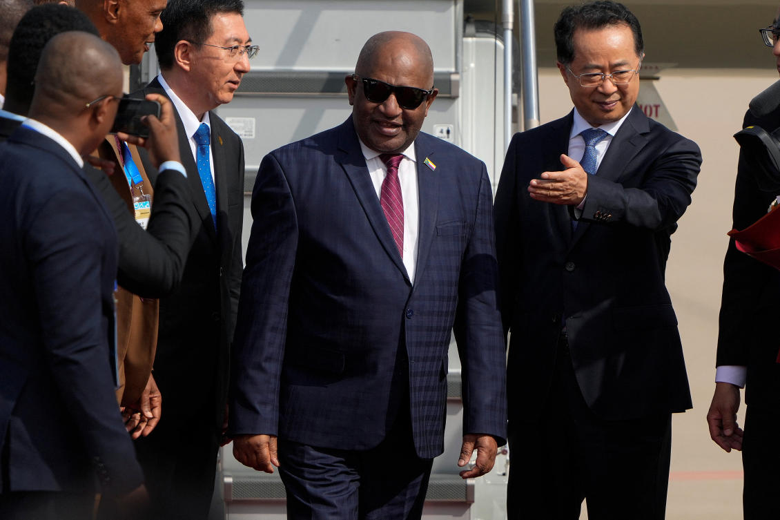 President Azali Assoumani, center, is shown the way by a Chinese official as he arrives at the Beijing Capital International Airport to attend the China Africa Forum, in Beijing, Sunday, Sept. 1, 2024. (REUTERS)