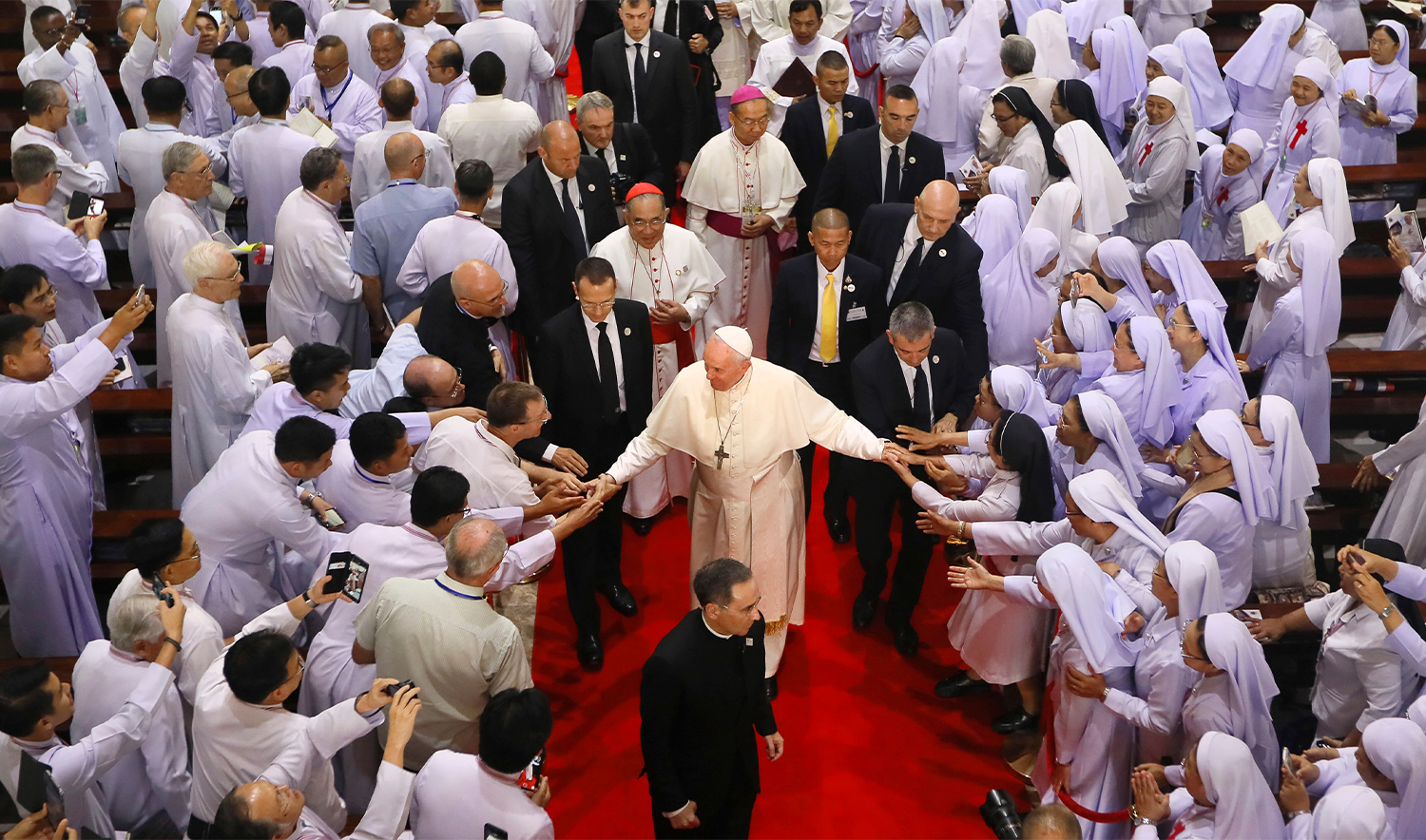 Priests, religious seminarians and Catechists touch the hands of Pope Francis as he leaves after meeting them at Saint Peter's Parish on the outskirts of Bangkok, Thailand, on November 22, 2019. (AP/File)