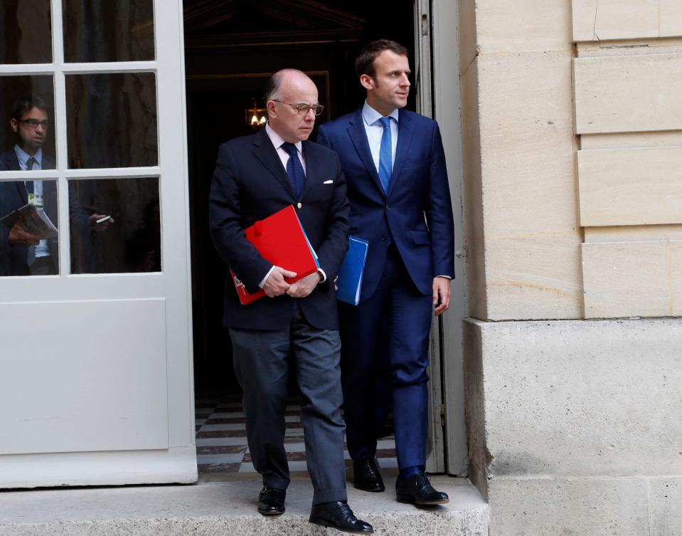 France's Minister of Interior Bernard Cazeneuve (L) and French Economy Minister Emmanuel Macron (R) leave the Hotel Matignon on May 28, 2017 in Paris following a meeting with French Prime and other members of the government and representatives of the oil sector. (File/AFP)