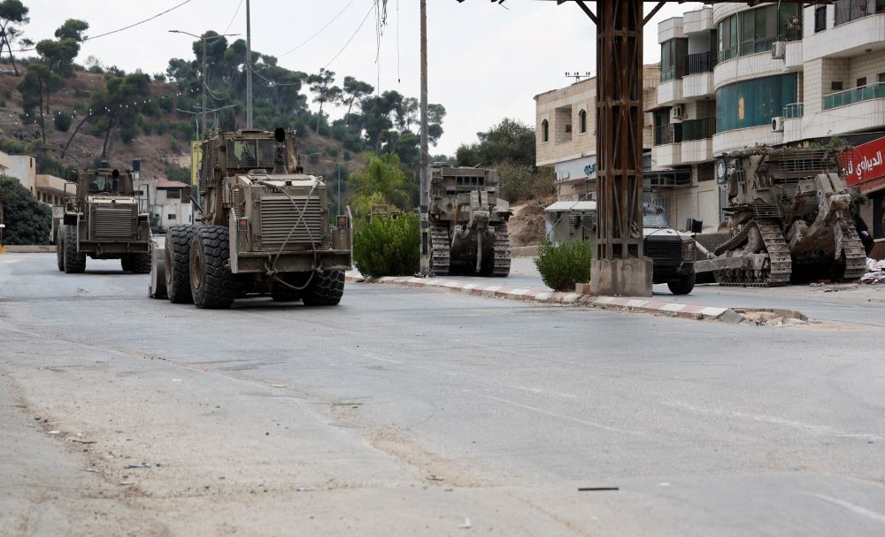 Israeli military engineering vehicles pass by a street during an Israeli raid, in Jenin, in the Israeli-occupied West Bank, Sept. 2, 2024. (Reuters)