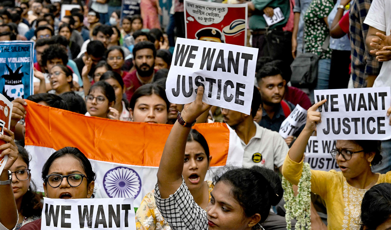 Junior doctors carry India's national flag and hold placards during a protest to demand the resignation of a city police commissioner and condemn the rape and murder of a medic, in Kolkata on September 2, 2024. (AFP)