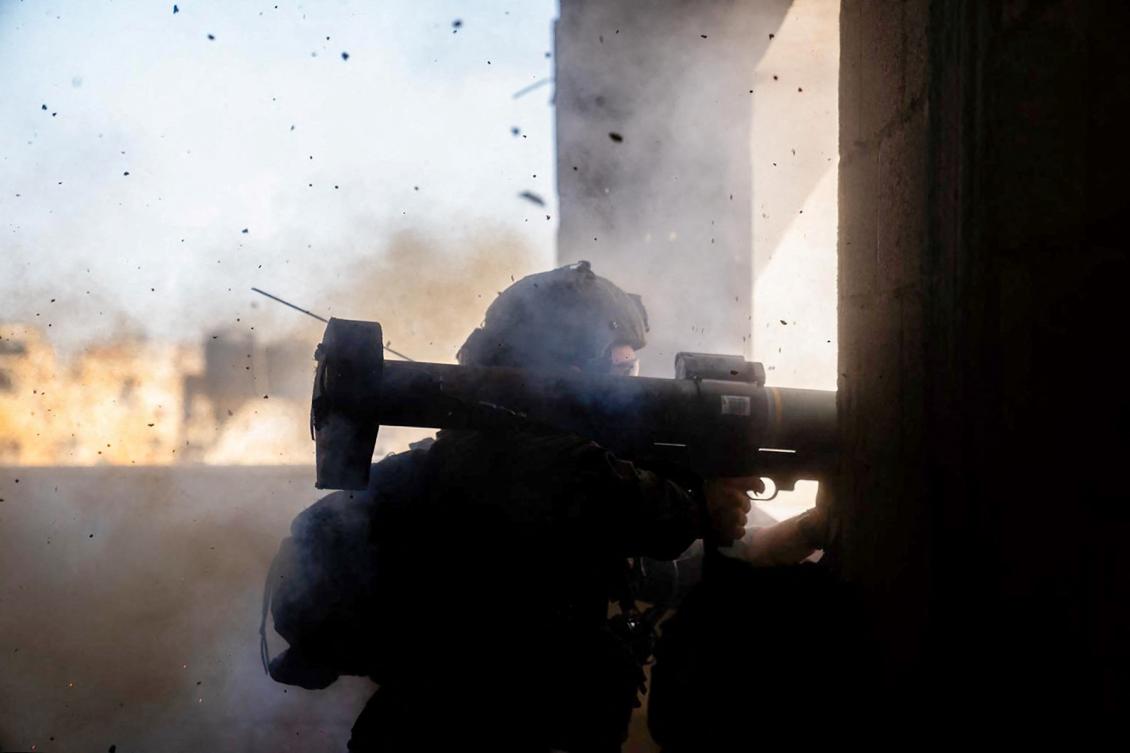 Israeli army soldier firing a weapon in an unspecified location in the Gaza Strip. (File/AFP)